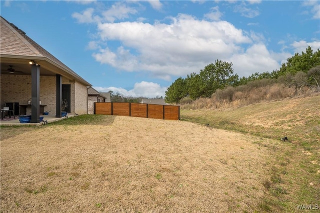 view of yard featuring fence and a patio