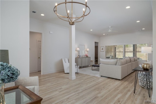 living room with a chandelier, light wood finished floors, visible vents, and recessed lighting