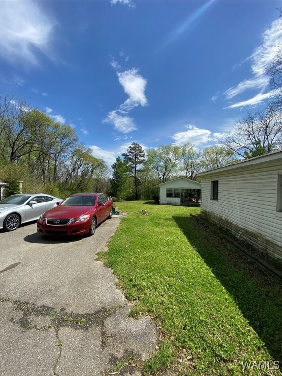 view of vehicle parking featuring a yard