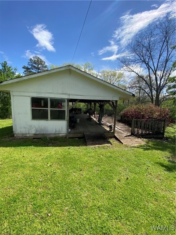 exterior space featuring a lawn and a wooden deck