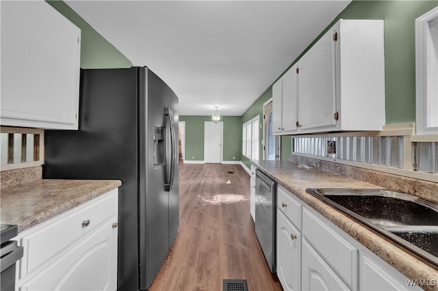 44 Maddox Rd, Nauvoo, AL 35578 - kitchen with light wood-style floors, appliances with stainless steel finishes, visible vents, and white cabinets