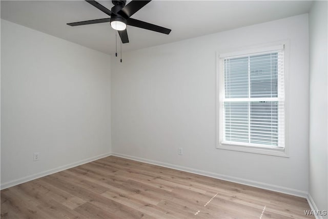 empty room with baseboards, light wood finished floors, and ceiling fan