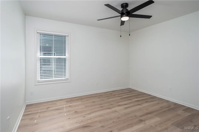 empty room featuring light wood-type flooring, baseboards, and ceiling fan