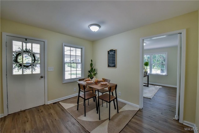 dining room with baseboards and wood finished floors