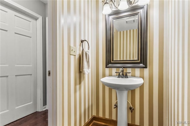 bathroom with a chandelier, hardwood / wood-style floors, and sink