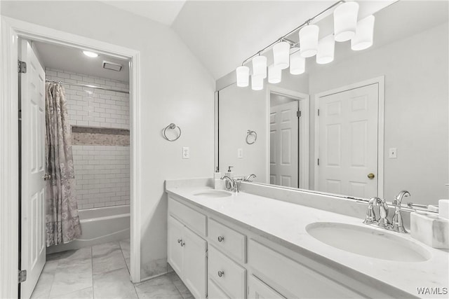 bathroom with vaulted ceiling, vanity, and shower / tub combo