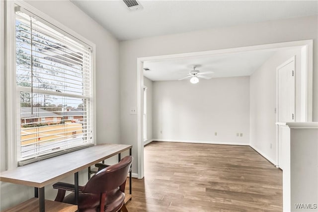 dining area with dark hardwood / wood-style floors, ceiling fan, and a healthy amount of sunlight