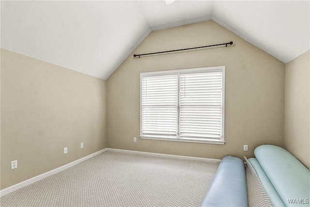 unfurnished room featuring carpet flooring and vaulted ceiling