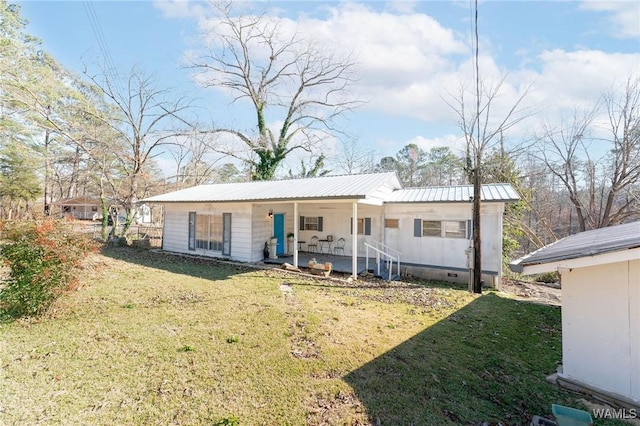 view of front of house featuring a porch, metal roof, crawl space, and a front yard