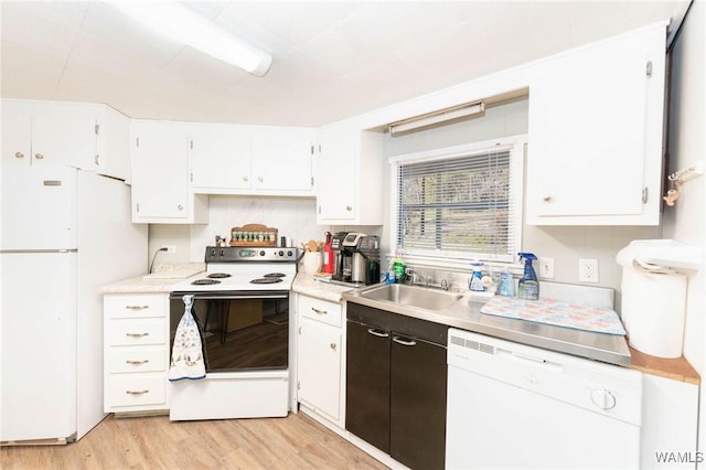 kitchen featuring white cabinets, white appliances, light countertops, and a sink