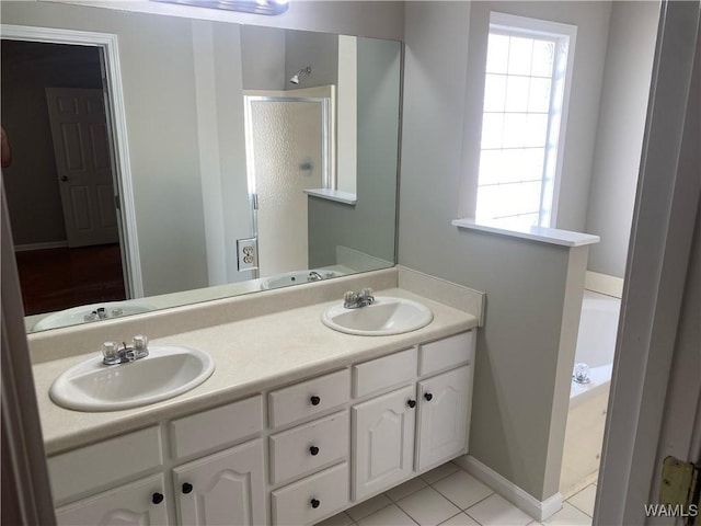 bathroom featuring double vanity, a sink, a bath, and a shower stall