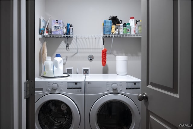 washroom with washing machine and clothes dryer