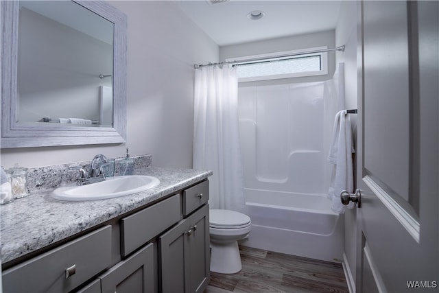 full bathroom featuring vanity, toilet, wood-type flooring, and shower / tub combo with curtain