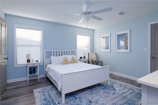 bedroom with ceiling fan and dark wood-type flooring