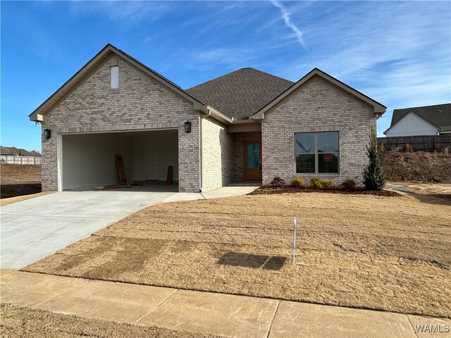 13761 Blackoak Dr, Northport, AL 35475 - view of front of property with concrete driveway, a garage, and brick siding
