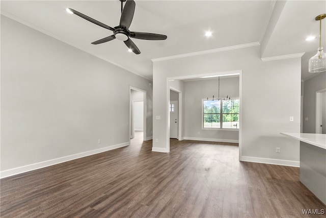 unfurnished living room featuring ceiling fan with notable chandelier, dark hardwood / wood-style flooring, and ornamental molding