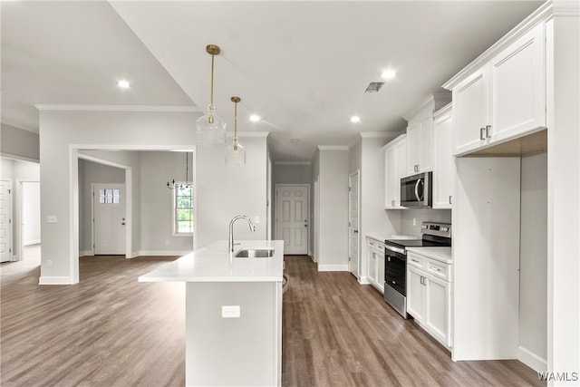 kitchen with sink, white cabinets, pendant lighting, and appliances with stainless steel finishes