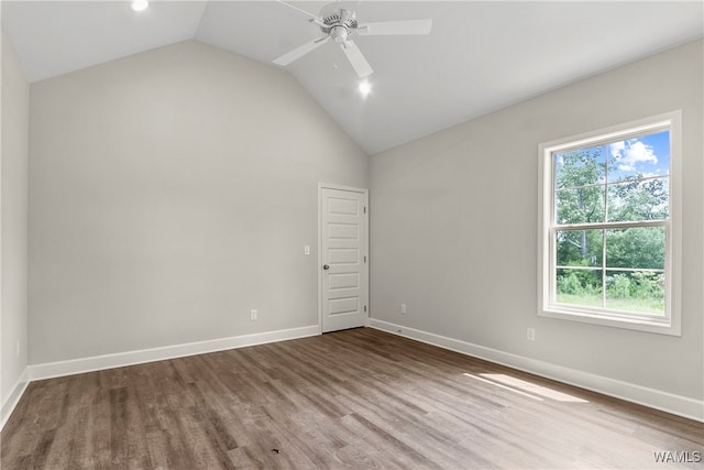 spare room with ceiling fan, hardwood / wood-style floors, and vaulted ceiling