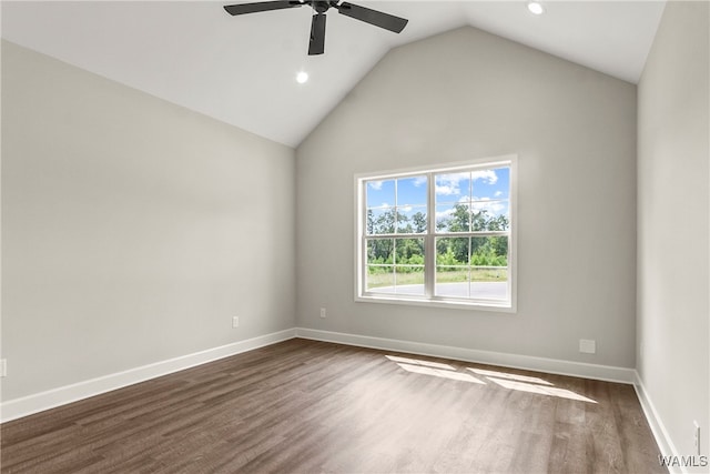 unfurnished room featuring ceiling fan, dark hardwood / wood-style flooring, and vaulted ceiling