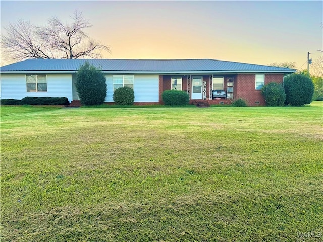 single story home with a front lawn and metal roof