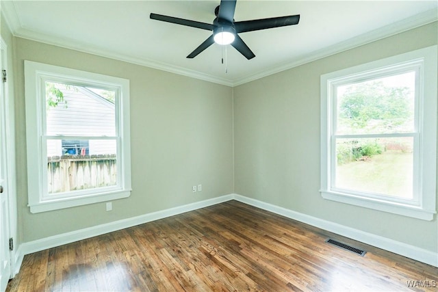unfurnished room with baseboards, ornamental molding, and dark wood-type flooring
