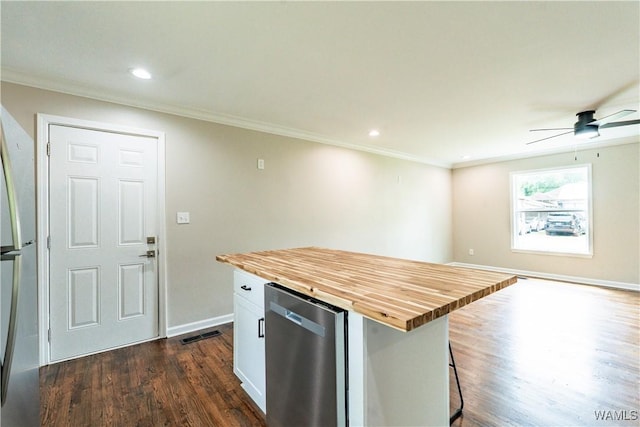 kitchen featuring ornamental molding, wooden counters, dark wood-style floors, and ceiling fan