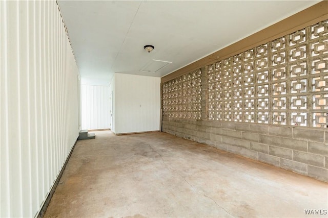 interior space with concrete floors and concrete block wall