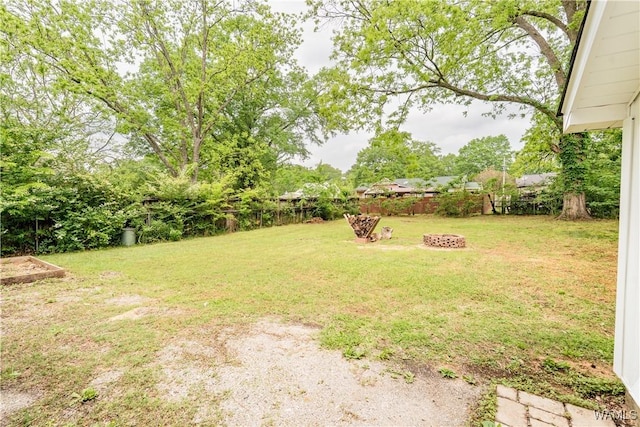 view of yard featuring an outdoor fire pit and a fenced backyard