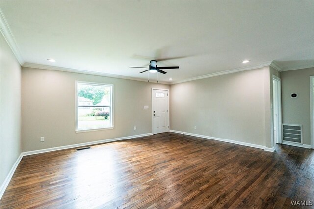 empty room with crown molding, visible vents, and ceiling fan