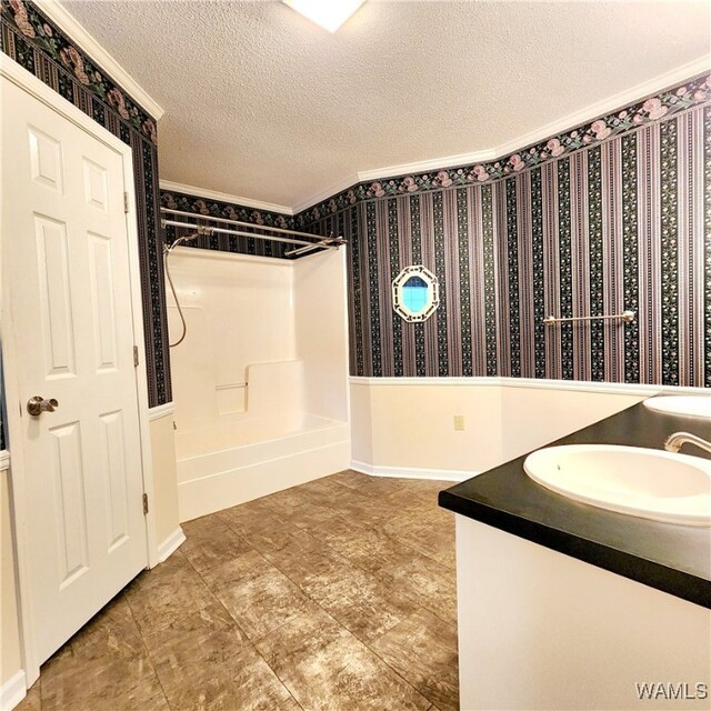 bathroom with shower / bathtub combination, vanity, and a textured ceiling