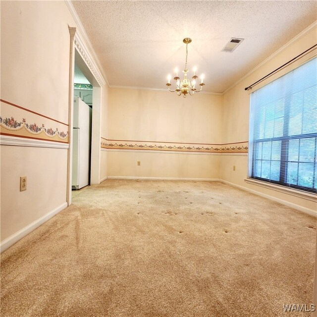 empty room featuring carpet flooring, crown molding, a chandelier, and a textured ceiling