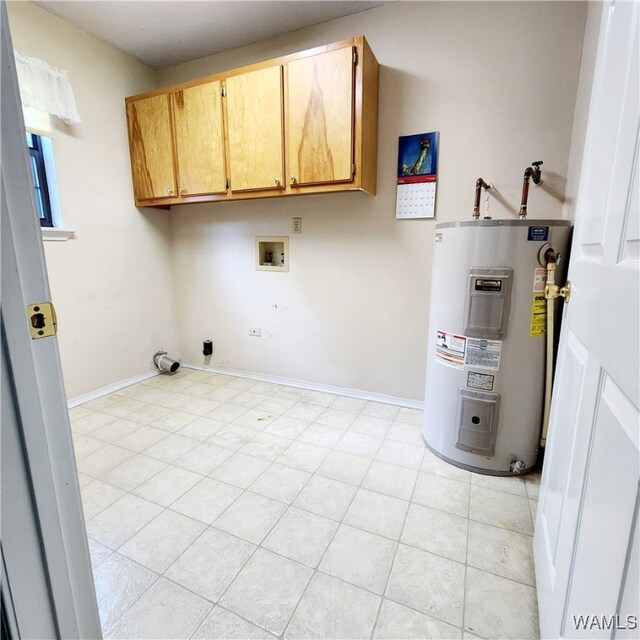 clothes washing area featuring washer hookup, cabinets, light tile patterned floors, and water heater