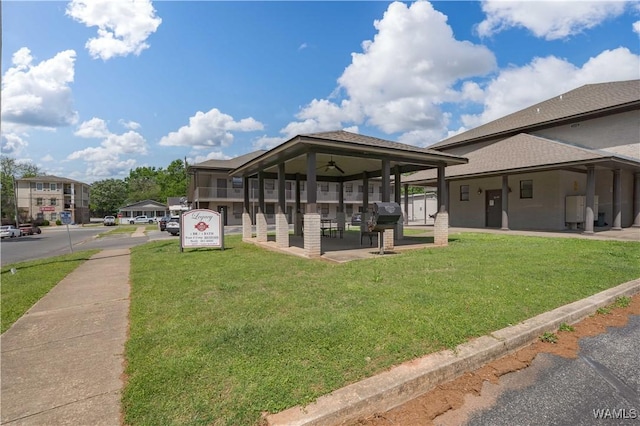 1212 12th St Unit 35, Tuscaloosa, AL 35401 - exterior space featuring a yard, a shingled roof, and ceiling fan