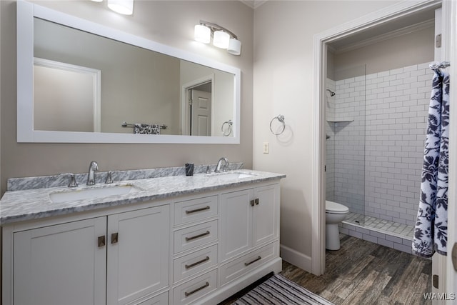 bathroom featuring toilet, hardwood / wood-style floors, vanity, and walk in shower