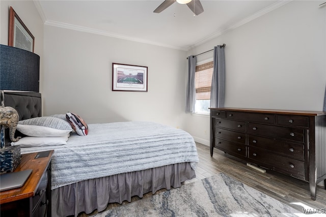 bedroom with hardwood / wood-style flooring, ceiling fan, and crown molding