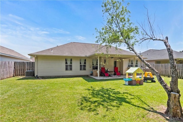 rear view of house with a lawn, a fenced backyard, a patio area, and cooling unit