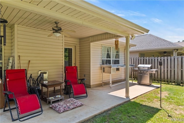 view of patio with grilling area, ceiling fan, and fence