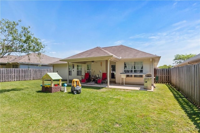 back of property featuring a fenced backyard, a ceiling fan, a lawn, and a patio area