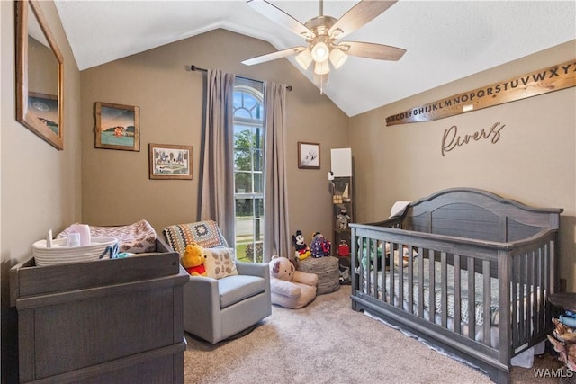 carpeted bedroom with a nursery area, ceiling fan, and vaulted ceiling
