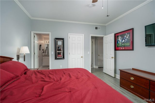 712 Frank Thomas Ave Unit 303, Tuscaloosa, AL 35401 - bedroom featuring ornamental molding, wood finished floors, baseboards, ensuite bath, and a ceiling fan