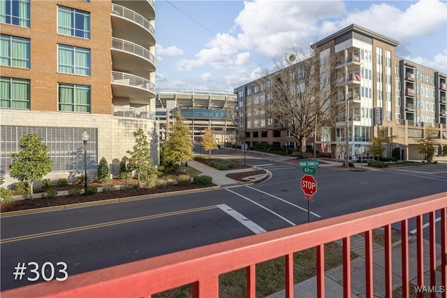 712 Frank Thomas Ave Unit 303, Tuscaloosa, AL 35401 - view of asphalt road with traffic signs, curbs, and sidewalks
