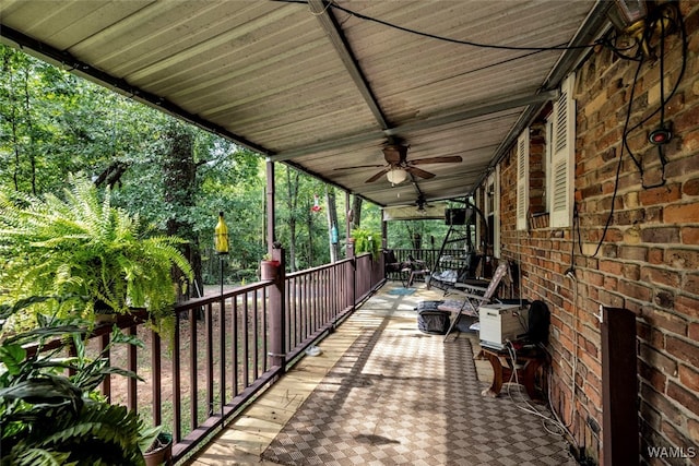 deck with ceiling fan and covered porch