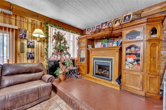 living room with wood walls and light tile patterned flooring