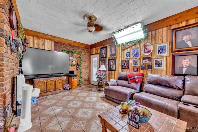 living room featuring brick wall, ceiling fan, and wood walls