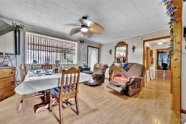 dining room featuring hardwood / wood-style flooring, ceiling fan, and crown molding