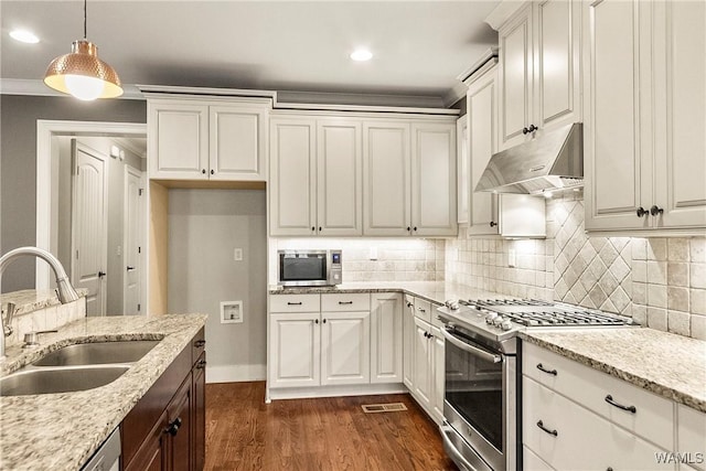 kitchen with white cabinets, hanging light fixtures, sink, and appliances with stainless steel finishes