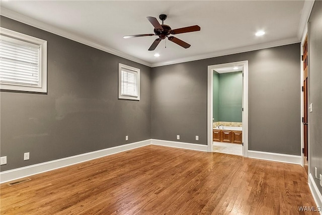 spare room with ceiling fan, light hardwood / wood-style floors, and ornamental molding