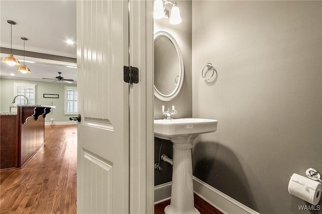 bathroom with ceiling fan, hardwood / wood-style flooring, and ornamental molding