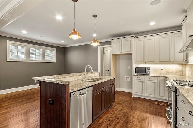 kitchen featuring sink, light stone countertops, a kitchen island with sink, and appliances with stainless steel finishes