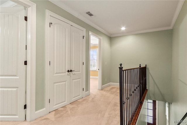 corridor featuring ornamental molding and light carpet